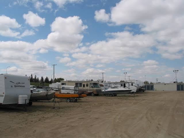 RVs, boats and trailers parked in the Stor All storage lot
